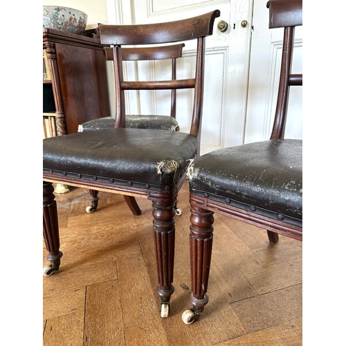 27 - A SET OF FOUR REGENCY MAHOGANY SIDE CHAIRS

the scrolled bar backs over square covered seats, on lob... 
