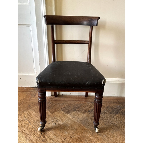27 - A SET OF FOUR REGENCY MAHOGANY SIDE CHAIRS

the scrolled bar backs over square covered seats, on lob... 