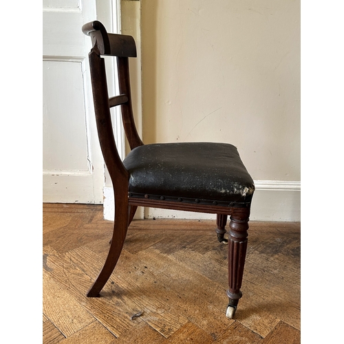 27 - A SET OF FOUR REGENCY MAHOGANY SIDE CHAIRS

the scrolled bar backs over square covered seats, on lob... 