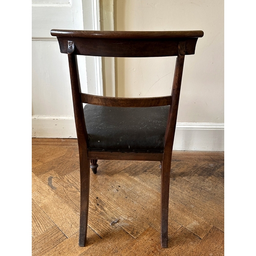 27 - A SET OF FOUR REGENCY MAHOGANY SIDE CHAIRS

the scrolled bar backs over square covered seats, on lob... 