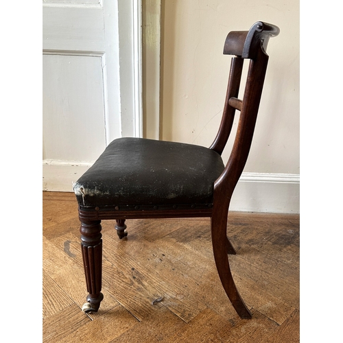 27 - A SET OF FOUR REGENCY MAHOGANY SIDE CHAIRS

the scrolled bar backs over square covered seats, on lob... 