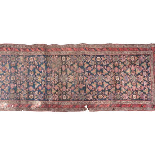 A GROUP OF FIVE PERSIAN RUGS 20th century, the largest with a red ...