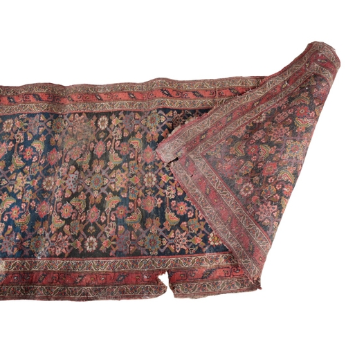 A GROUP OF FIVE PERSIAN RUGS 20th century, the largest with a red ...