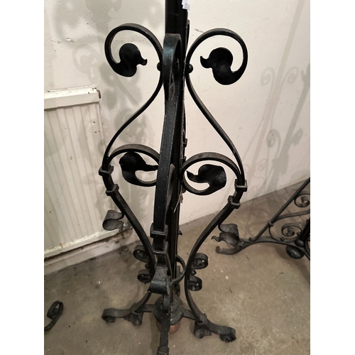 43 - A GROUP OF THREE VICTORIAN COPPER AND WROUGHT IRON STANDING LAMP BASES

the tallest with a planished... 