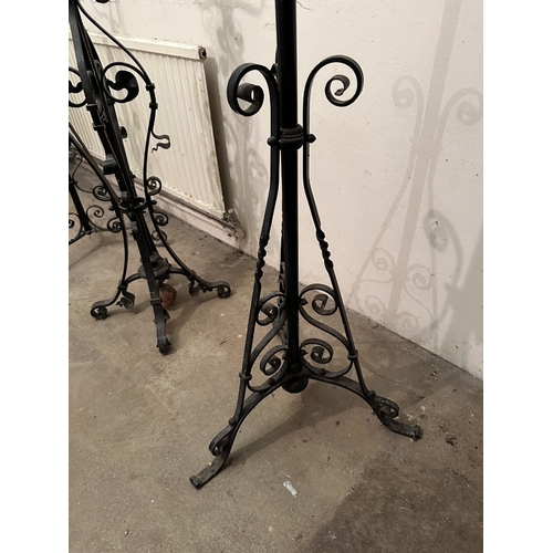 43 - A GROUP OF THREE VICTORIAN COPPER AND WROUGHT IRON STANDING LAMP BASES

the tallest with a planished... 
