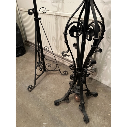 43 - A GROUP OF THREE VICTORIAN COPPER AND WROUGHT IRON STANDING LAMP BASES

the tallest with a planished... 