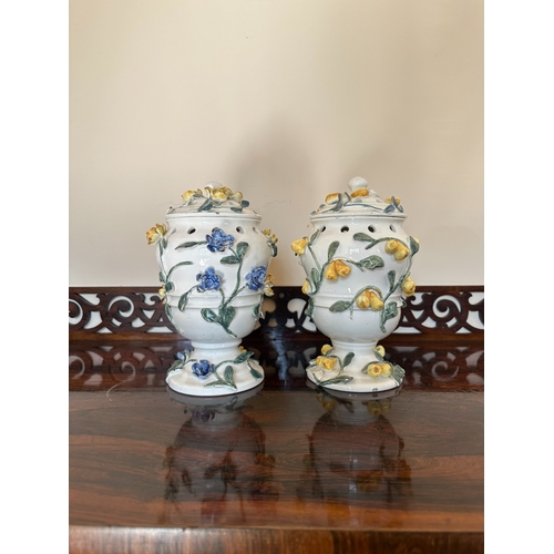 49 - A NEAR PAIR OF CONTINENTAL FAIENCE POT POURRI VASES

of baluster form with pierced covers and collar... 