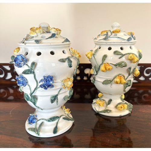 49 - A NEAR PAIR OF CONTINENTAL FAIENCE POT POURRI VASES

of baluster form with pierced covers and collar... 