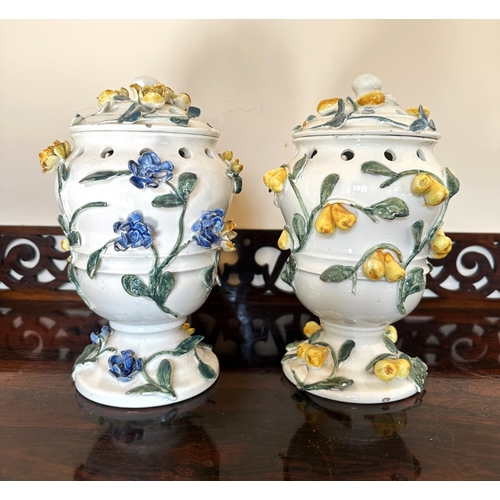 49 - A NEAR PAIR OF CONTINENTAL FAIENCE POT POURRI VASES

of baluster form with pierced covers and collar... 