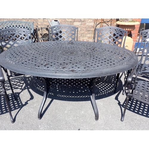 3 - A CAST METAL OVAL GARDEN TABLE AND SIX CHAIRS

with lattice design, the table 115 x 168cm