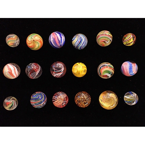 A COLLECTION OF ANTIQUE GLASS MARBLES one with 'gold' flecks, some with ...