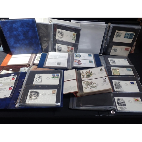 A COLLECTION OF FIRST DAY COVERS in albums
