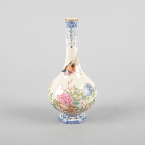 102 - A SMALL CHINESE PORCELAIN FAMILLE ROSE BOTTLE VASE

bearing a four character Qianlong mark to the ba... 