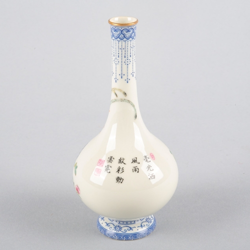 102 - A SMALL CHINESE PORCELAIN FAMILLE ROSE BOTTLE VASE

bearing a four character Qianlong mark to the ba... 