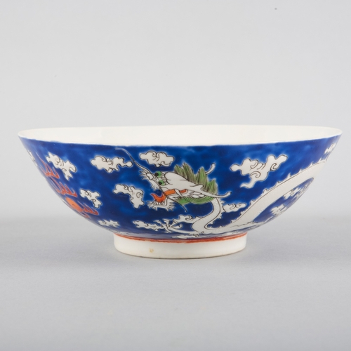 117 - A PAIR OF CHINESE PORCELAIN 'DRAGON' BOWLS

20th century, the blue grounds decorated in white enamel... 