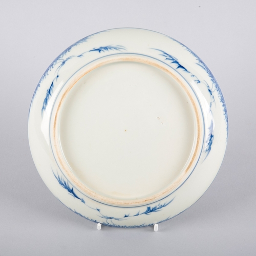 88 - A CHINESE PORCELAIN BLUE AND WHITE LANDSCAPE DISH

possibly early Qing, decorated with a river scene... 