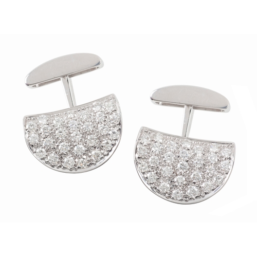 303 - A PAIR OF PAVE SET DIAMOND CUFFLINKS

of shaped half circular form set with round brilliant cut diam... 