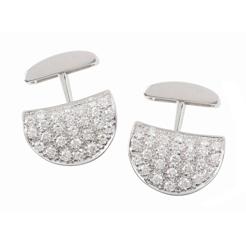 303 - A PAIR OF PAVE SET DIAMOND CUFFLINKS

of shaped half circular form set with round brilliant cut diam... 
