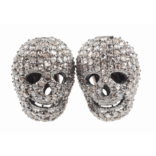 307 - A PAIR OF DIAMOND SET SKULL CUFFLINKS

the pave set skulls c. 14mm x 9mm, set in silver, c. 7.9 gram... 