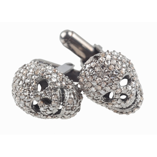 307 - A PAIR OF DIAMOND SET SKULL CUFFLINKS

the pave set skulls c. 14mm x 9mm, set in silver, c. 7.9 gram... 
