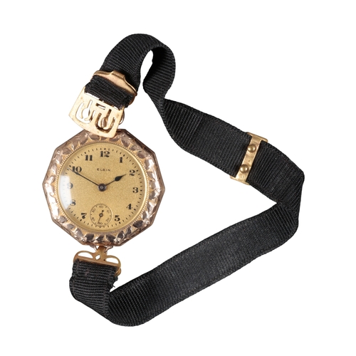 513 - ELGIN: A 9CT GOLD FOB WATCH

converted to a wristwatch, with manual wind movement, gold dial, black ... 