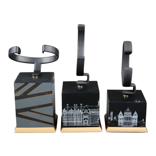 592 - A COLLECTION OF SEVEN SHOP WATCH DISPLAY STANDS

of varying sizes, displaying scenes of London inclu... 