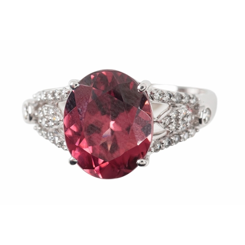 93 - AN 18CT WHITE GOLD ZIRCON AND DIAMOND RING

the oval mixed cut zircon, c. 11mm x 9mm x 5.5mm, four c... 