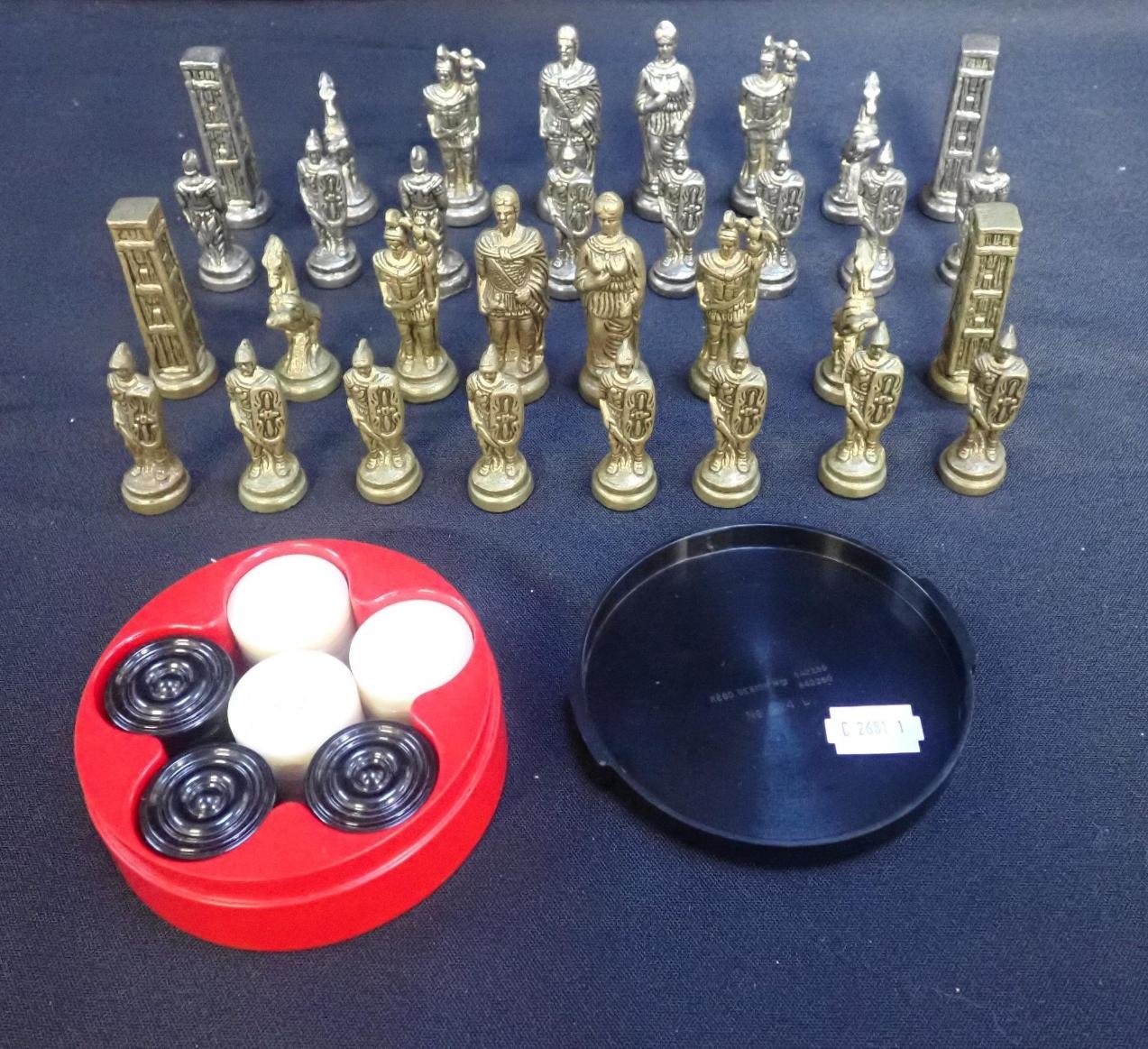 A BRASS AND STEEL ROMAN CHESS SET and a set of Bandalasta draught counters