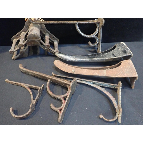 104 - A COLLECTION OF OLD CAST IRON SADDLE RACKS

and similar fittings
