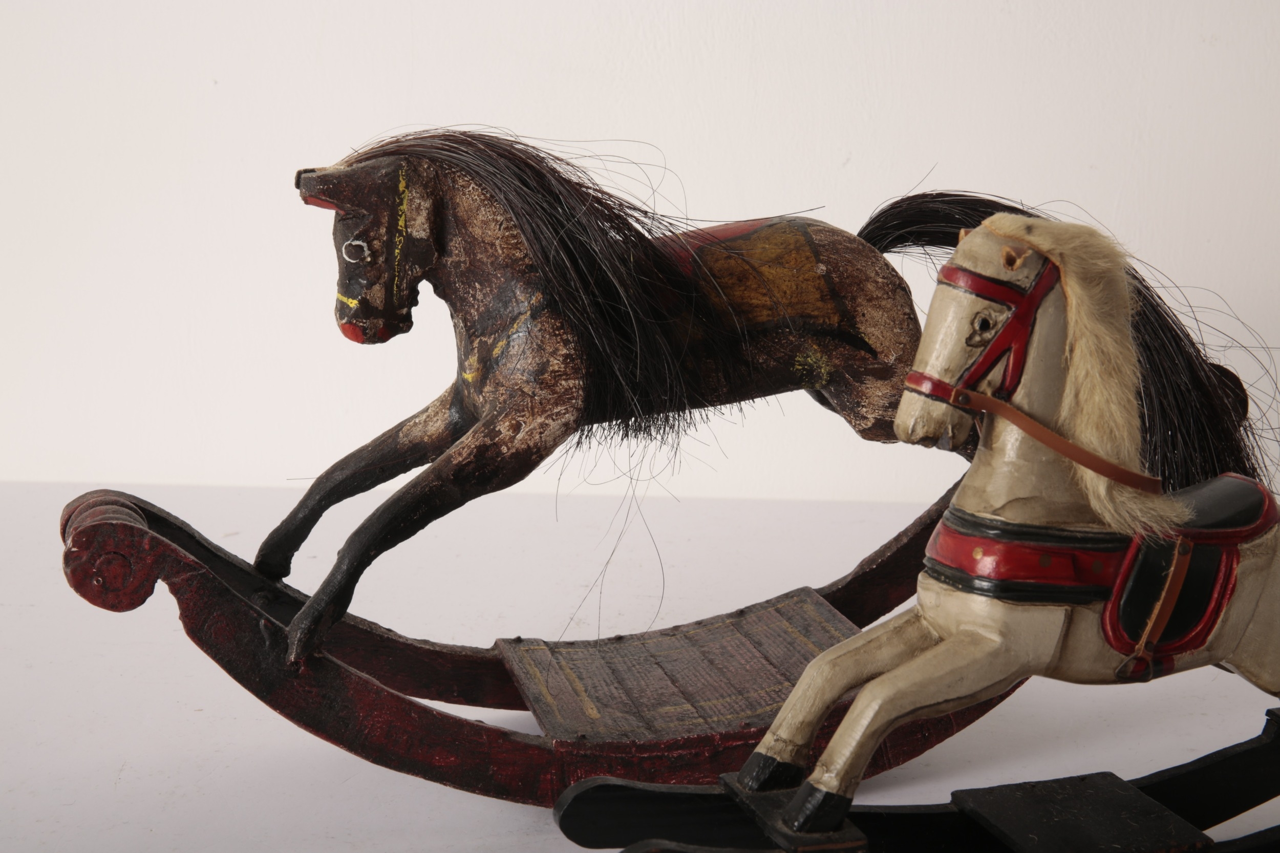 A GROUP OF FIVE MINIATURE ROCKING HORSES the largest a painted wood ...