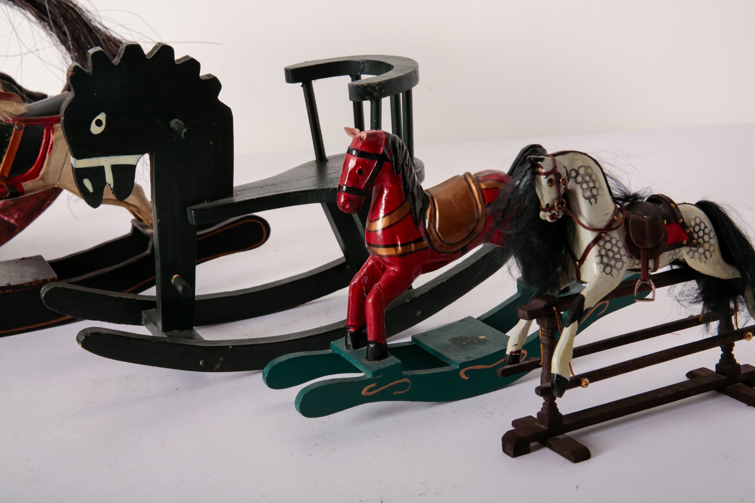 A GROUP OF FIVE MINIATURE ROCKING HORSES the largest a painted wood ...