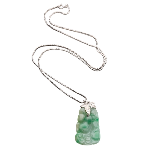 134 - A JADE PENDANT NECKLACE the carved jade pendant, with a white metal foliage suspension, attached to ... 