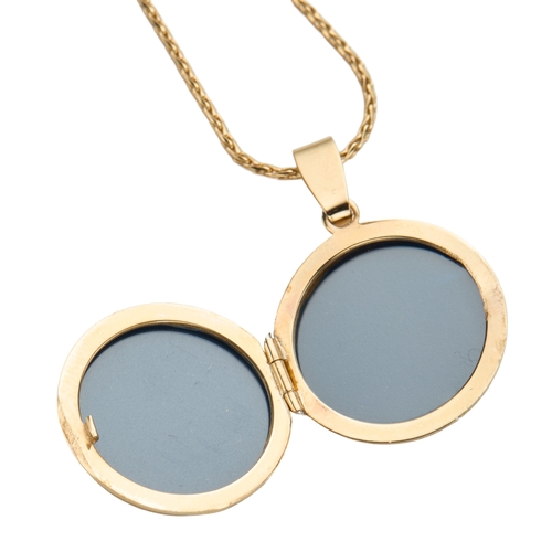 136 - A LOCKET ON CHAIN the round 9ct gold locket approximately 30mm drop, British hallmarks, on a 9ct gol... 