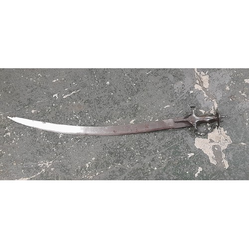 652 - A polished steel Indian Tulwar sword with curved blade, disc hilt and knuckle guard. Blade length 68... 