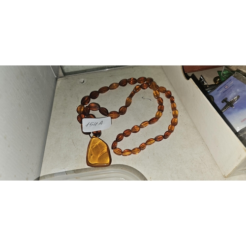 154A - PRESSED AMBER NECKLACE WITH POLISHED PENDANT NIGGET