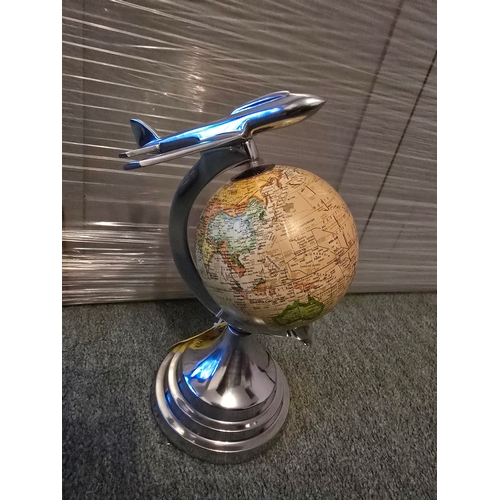 124 - Polished aluminium airplane on globe