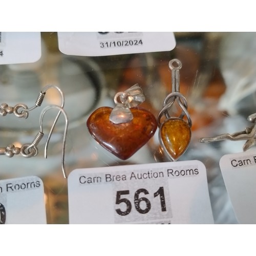 561 - 2 Silver pendants with amber