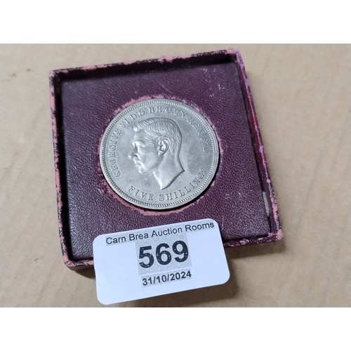 569 - Five shillings coin in box