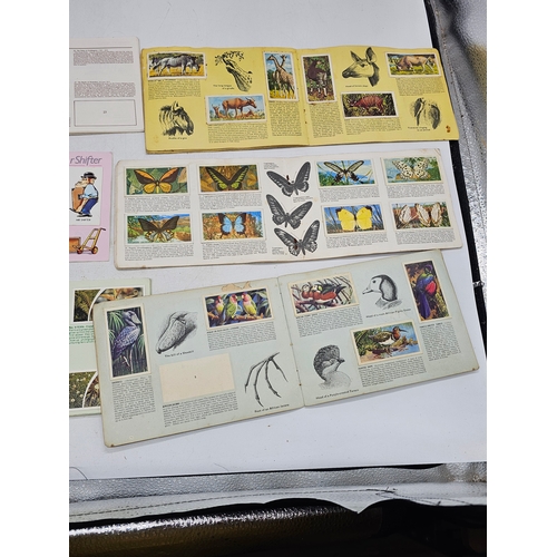 573 - Cigarette cards in albums