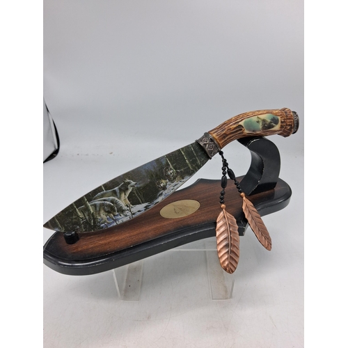 390 - Display Knife on stand featuring wolf decoration