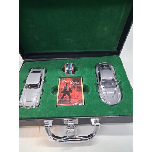 325 - James Bon case by Corgi with 2 classic Bond Cars, playing cards and gambling chips