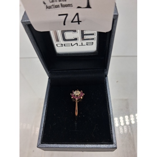 74 - A 9k gold  ruby and diamond flowerhead cluster ring
