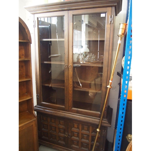 187 - Wooden display cabinet in two sections with glass doors and cupboards