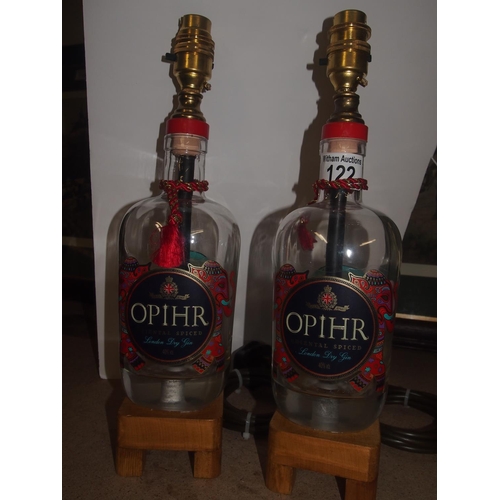 122 - A pair of upcycled Ophr Oriental spiced gin table lamps on wooden plinths (PAT tested)