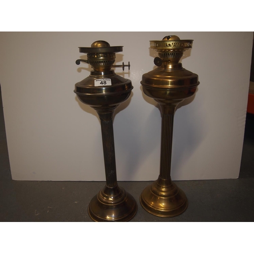 48 - Two vintage brass oil lamps with globes