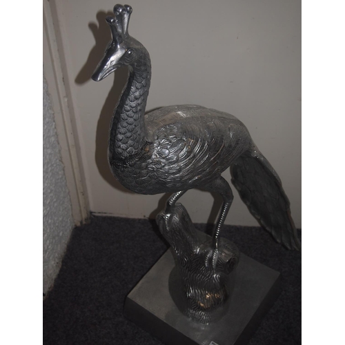 72 - A life size metal silver coloured peacock on a plinth