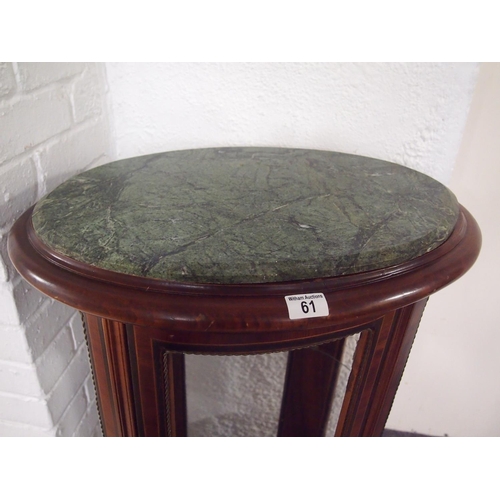 61 - An antique style mahogany oval display cabinet on brass feet, possibly French.  Decorative banding a... 