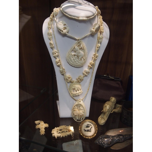 74 - Three vintage gentleman wrist watches plus two lady's wrist watches, various hand carved necklaces a... 