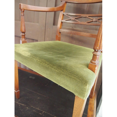85 - An Edwardian style open arm elbow chair with green velvet upholstery, tapered legs, and flower detai... 