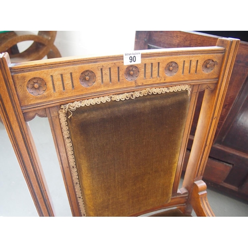 90 - An antique mahogany low bedroom chair with carved floral detailing to back, dark green velvet uphols... 